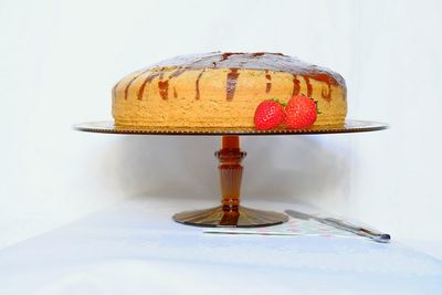 Close-up of cake on table against white background