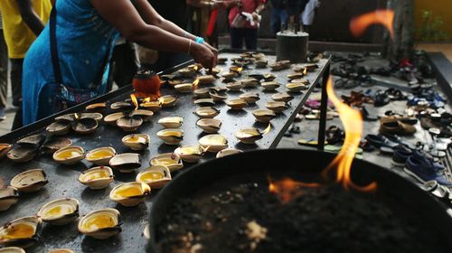 A devotee with oil lamp during thaipusam.