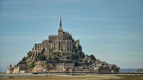 View of historic building le mont saint-michel against sky