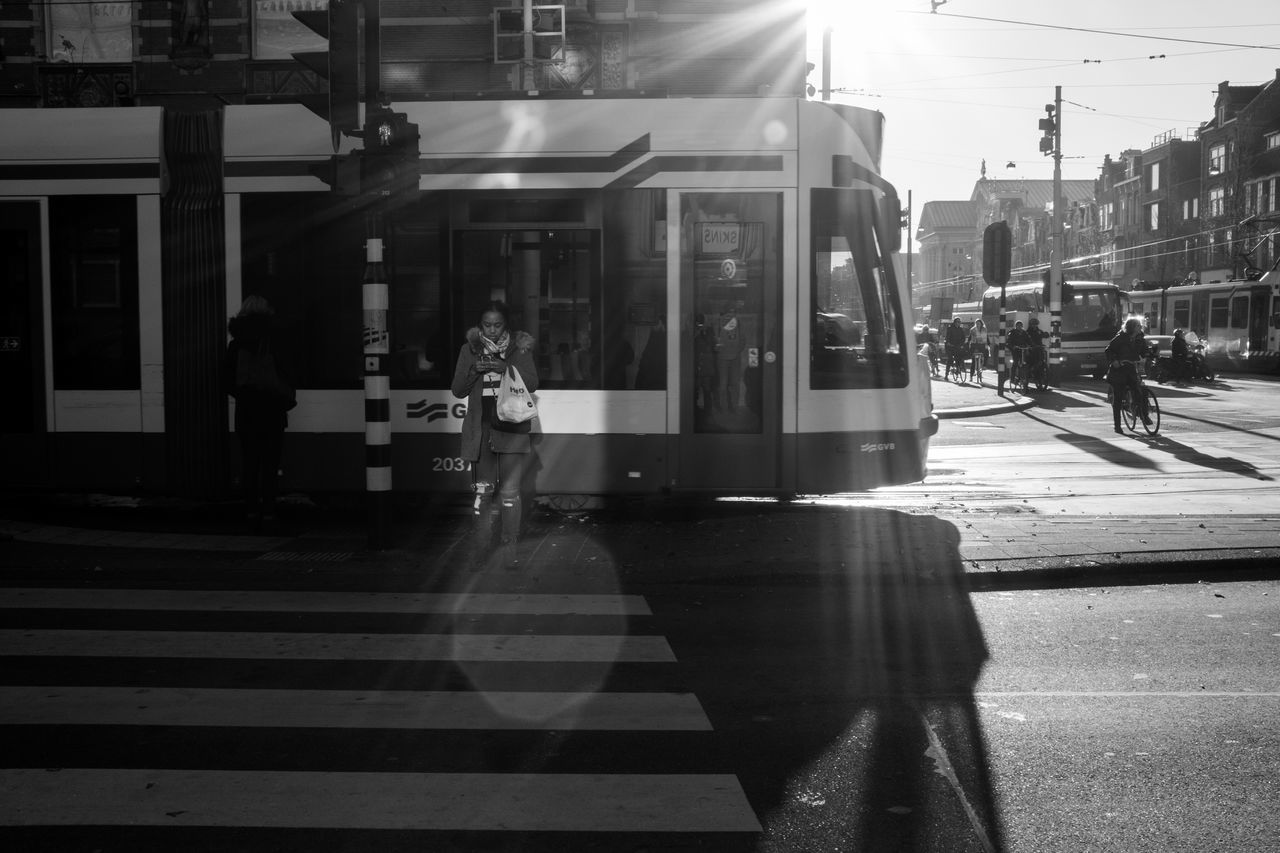 REFLECTION OF MAN ON CITY STREET