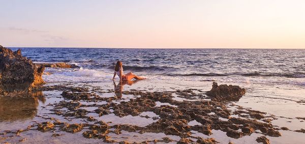 Scenic view of sea against clear sky during sunset