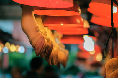Close-up of hand holding red leaves at market stall
