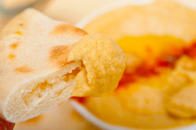 Traditional chickpeas hummus with pita bread and paprika on top