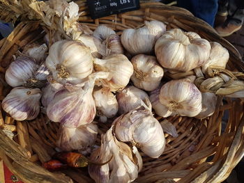 Close-up of onions in basket for sale at market stall
