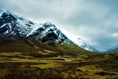 Scenic view of snowcapped mountains against sky