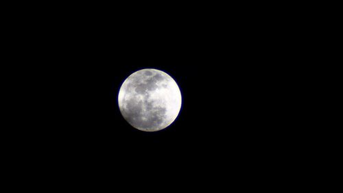 Low angle view of moon against clear sky at night