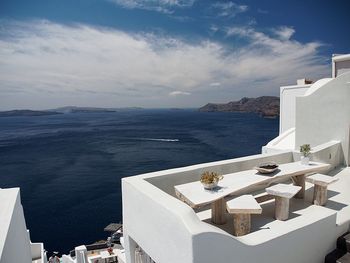 Tourist resort and seascape against sky