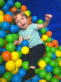 Full length of boy playing ball pool