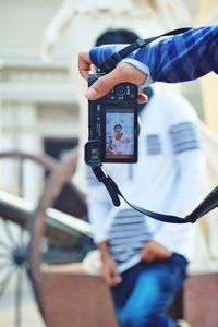 Low section of woman photographing with mobile phone