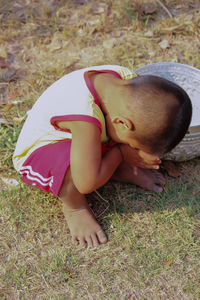 Young woman lying on grass