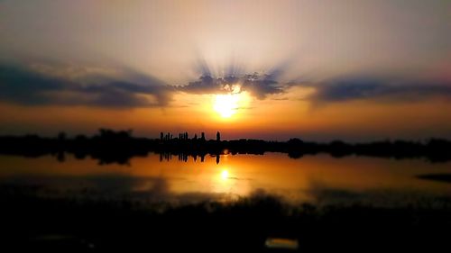 Scenic view of lake against romantic sky at sunset