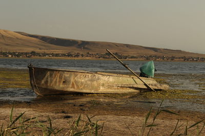 Abandoned boat at the lake bank 