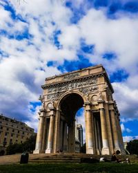 Low angle view of historical building against cloudy sky