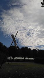 Traditional windmill on field against sky