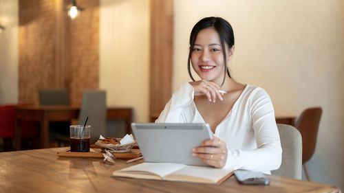 Young woman using laptop at table