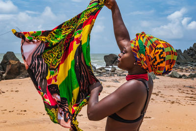 Dancing ghana woman on the beautiful beach of axim, located in ghana west africa