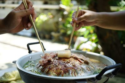 Thailand style bbq grill on a charcoal fire that is located on the bottom with pork, shrimp, squid 