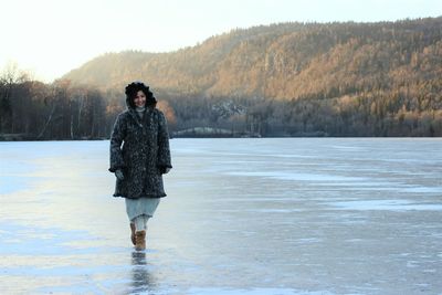 Portrait of woman on snow covered landscape