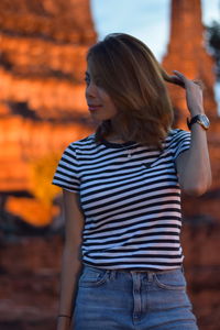 Woman standing against old ruin