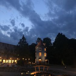 Illuminated building against sky at night