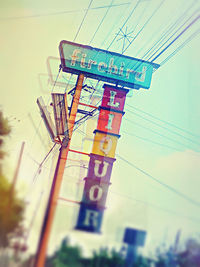 Low angle view of road sign against sky