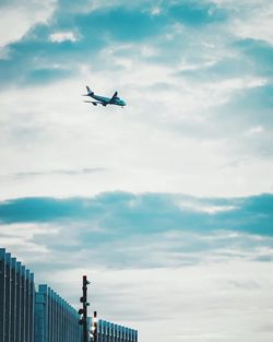 Low angle view of airplane flying in sky