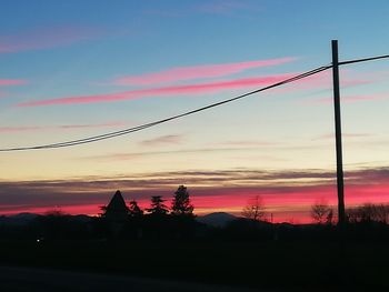 Silhouette trees against sky during sunset