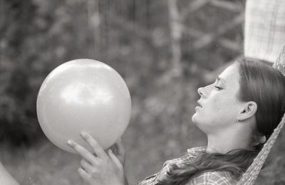 Close-up of hand holding balloons