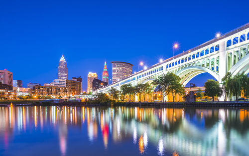 Reflection of buildings in city at waterfront