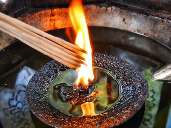 High angle view of burning incenses from flame