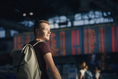 Traveling by airplane. portrait of man walking through airport terminal.