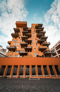 Low angle view of building against cloudy sky