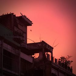 Low angle view of silhouette building against sky during sunset