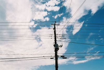 Low angle view of electricity pylon against sky