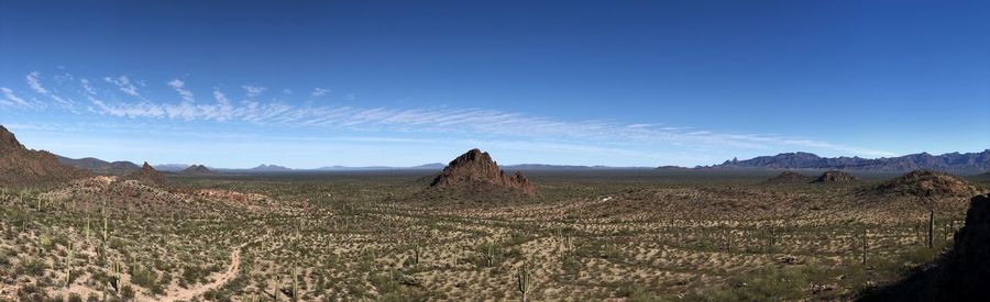 Panoramic view of arid landscape against sky