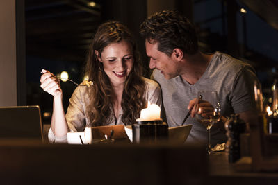 Smiling couple having dinner together