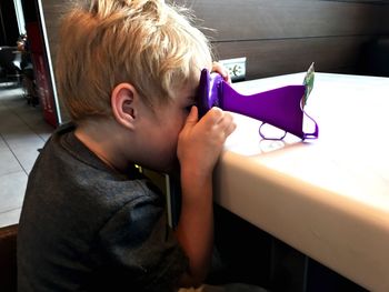 Side view of boy playing at home