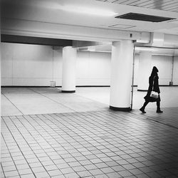 Full length of woman standing by railing