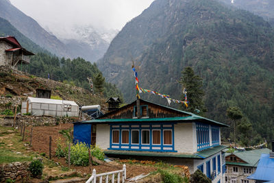 Buildings against mountain range