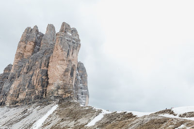 Low angle view of rock formation against sky