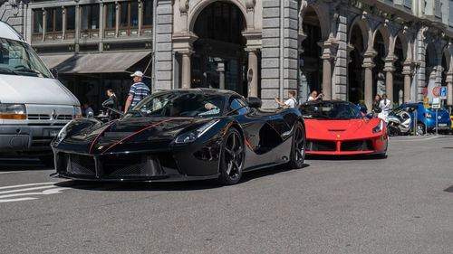 Cars on street by buildings in city