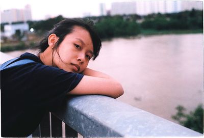 Portrait of young woman looking at lake