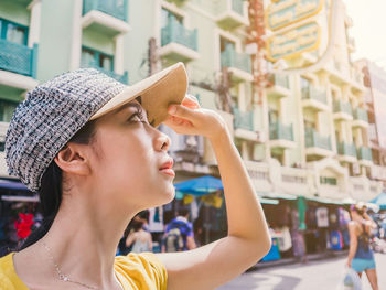 Young woman looking up in the city