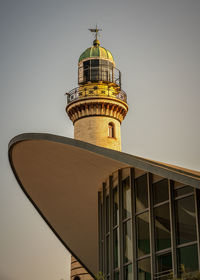 Low angle view of lighthouse warnemünde against building