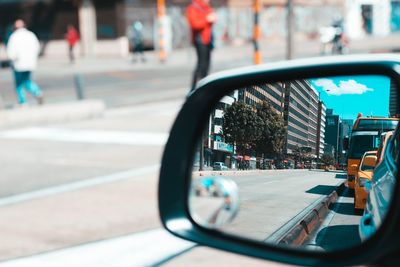 Vehicles reflecting on car side-view mirror