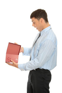 Midsection of man holding umbrella against white background