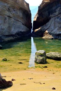 Scenic view of rock formations by beach