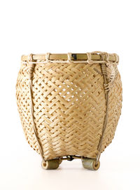 Close-up of wicker basket over white background