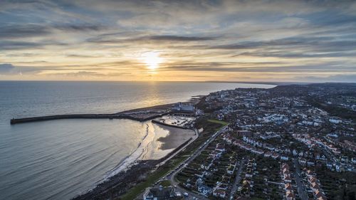 Aerial view of sea against sky during sunset