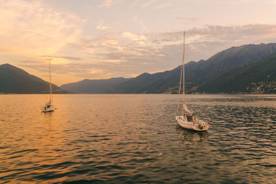 Lake locarno by sunset with sailing boats